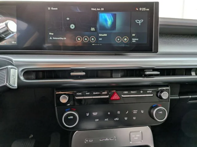The IONIQ 9 center touchscreen with the physical climate and audio controls below it